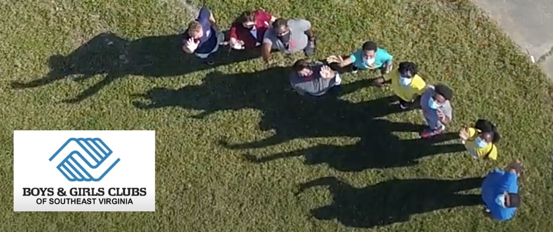 Aerial view of masked children waving on a lawn, with the Boys & Girls Clubs of Southeast Virginia logo overlaid.